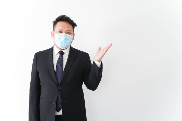 istock Businessman in suit with a mask 1277286751