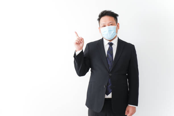 istock Businessman in suit with a mask 1277286755