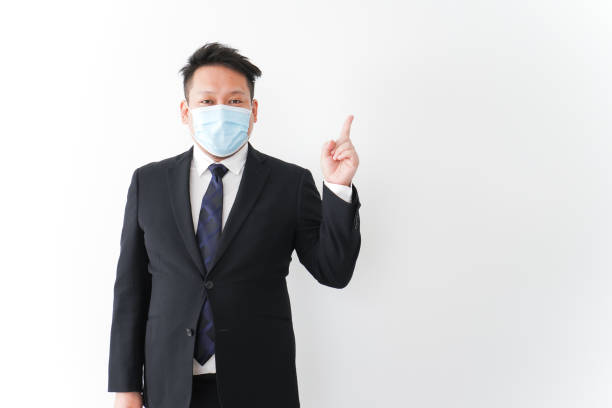 istock Businessman in suit with a mask 1277286756