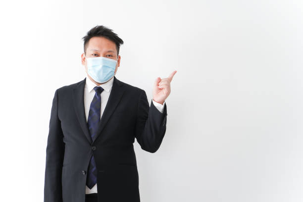 istock Businessman in suit with a mask 1277286757