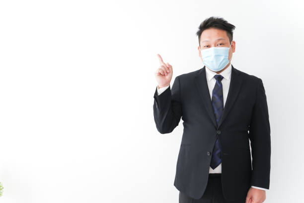 istock Businessman in suit with a mask 1277286759