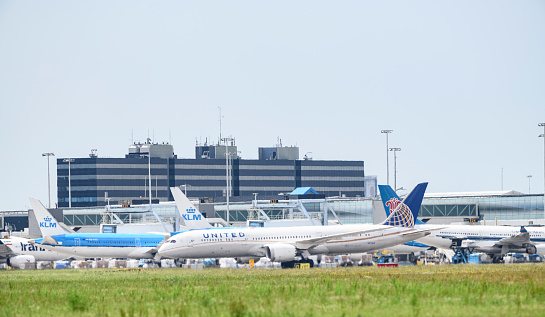 Gdansk, Poland – August 16, 2022: The Lech Walesa airport with planes on the board and technical crew waiving at a plane in the distance