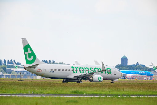 Boeing 737 of Transavia airlines parked on the tarmac at Schiphol airport during a  springtime day. Transavia is a Dutch low-cost airline and a subsidiary of KLM, part of the Air France–KLM group