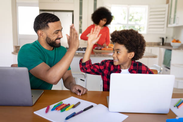 istock Father and son high fiving each other at home 1277288802