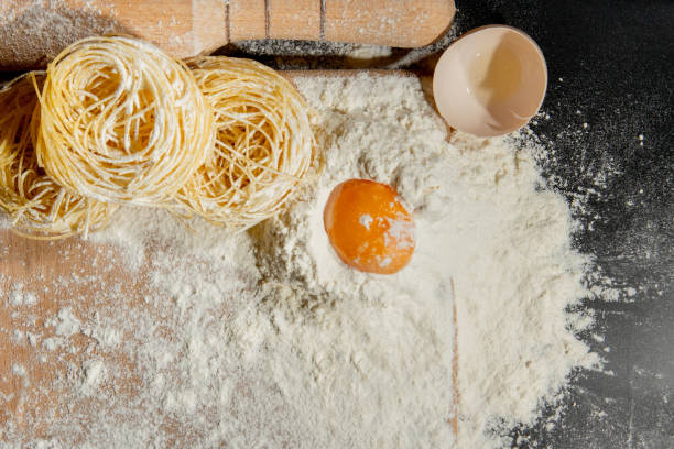 istock flat lay with rolling pin and ingredients for italian pasta arranged on black tabletop 1277289069