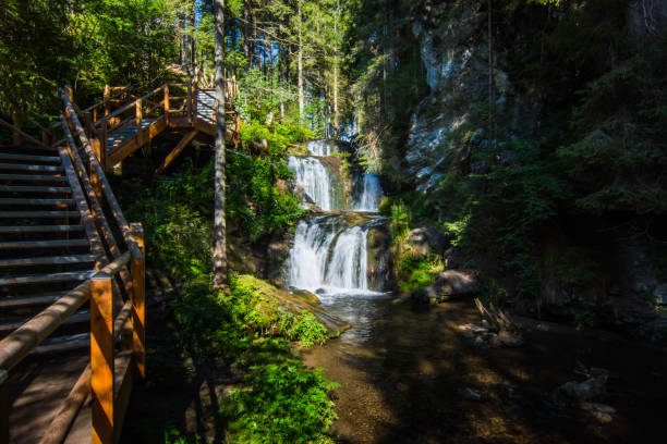 istock dark gorge with wooden stairs and little waterfall 1277290144
