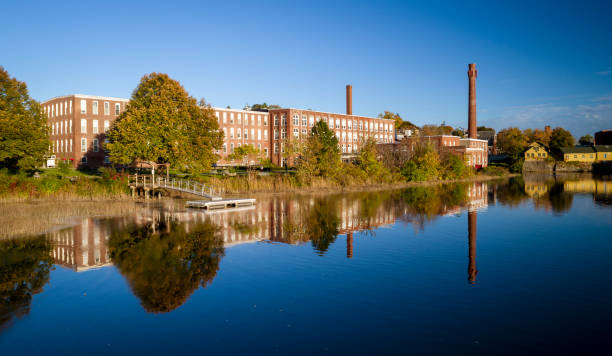 istock A 19th century textile mill has been renovated for modern use, seen reflected in the neighboring river 1277290208