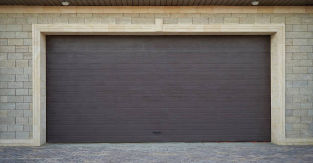 istock Wide automatic garage door and luxury garage with stone walls 1277291290