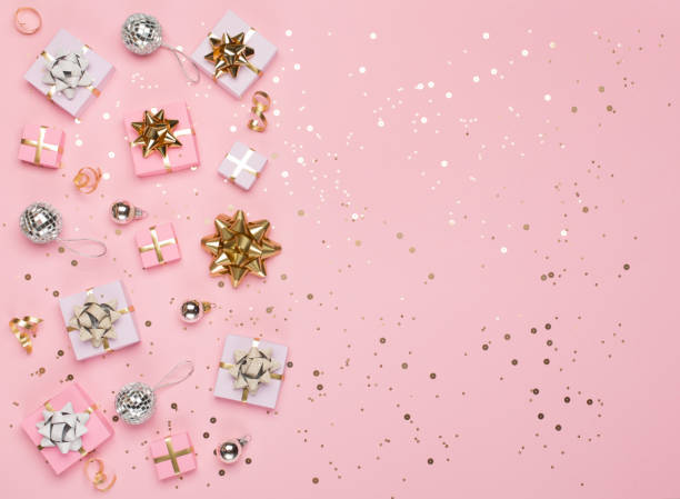 istock Gold and silver decorations, mirror disco balls, gifts on pastel pink paper background. 1277291663