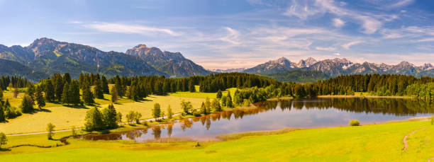 istock panoramic landscape in Bavaria with mountain range and lake 1277293191