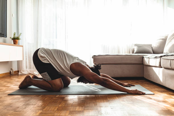istock Healthy young man practicing yoga at home 1277293907