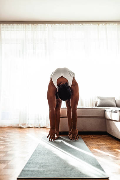 istock Young black man training and stretching at home 1277294717