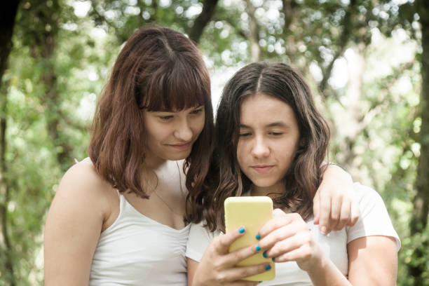 istock Teenagers talking and using phones 1277298410