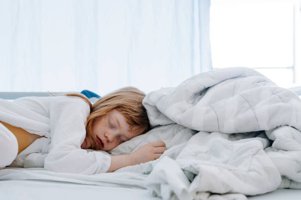 istock Girl sleeping on bed in hospital ward 1277299025