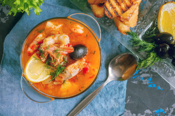 istock Seafood soup, salmon and cod with potatoes. Served with lemon and olives. Close up 1277299781