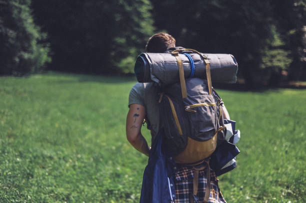 istock Young bearded man hiking, exploring the mountain 1277300111
