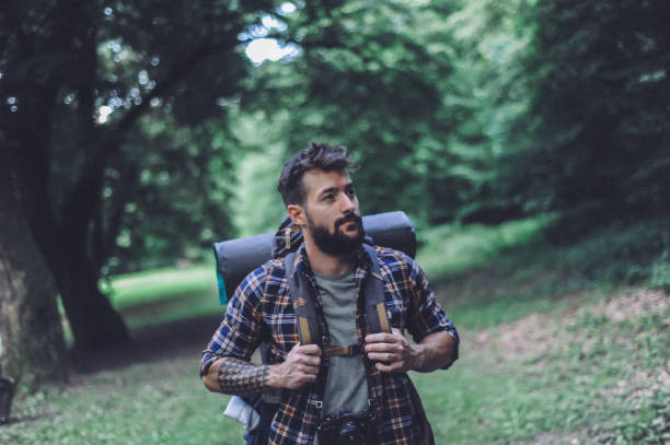 istock Young bearded man hiking, exploring the mountain 1277300118
