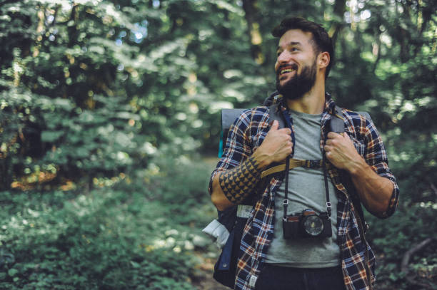 istock Young bearded man hiking, exploring the mountain 1277300643