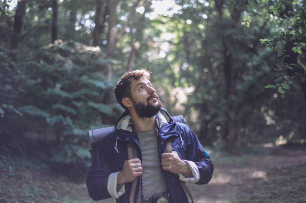 istock Young bearded man hiking, exploring the mountain 1277300690