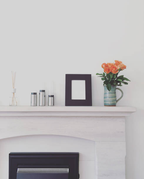 Home decor above fireplace Marble fireplace with candle holders, picture frame, roses and diffuser candlestick holder photos stock pictures, royalty-free photos & images