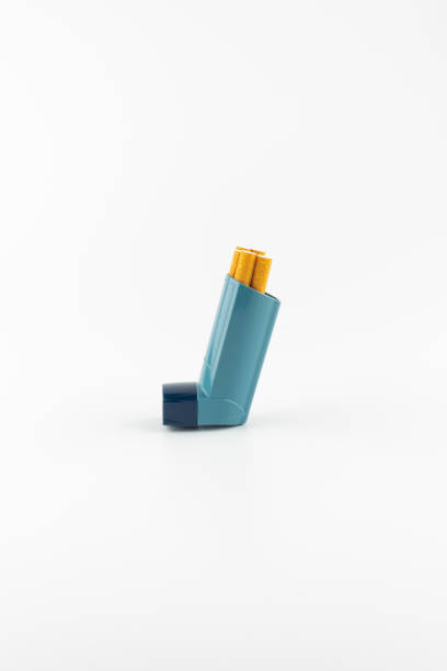 istock Salbutamol inhaler with cigarettes on white background ( Asthma is not compatible with tobacco) 1277302882