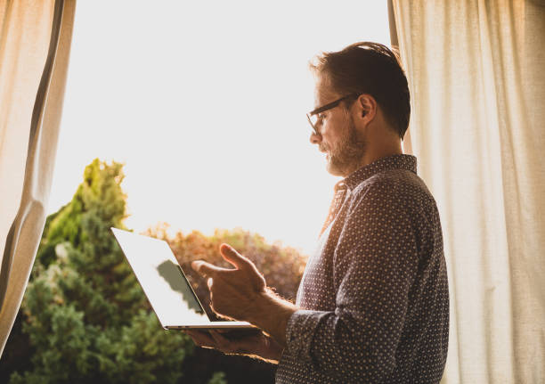 istock Man (businessman) having video chat on laptop computer outdoor 1277303654