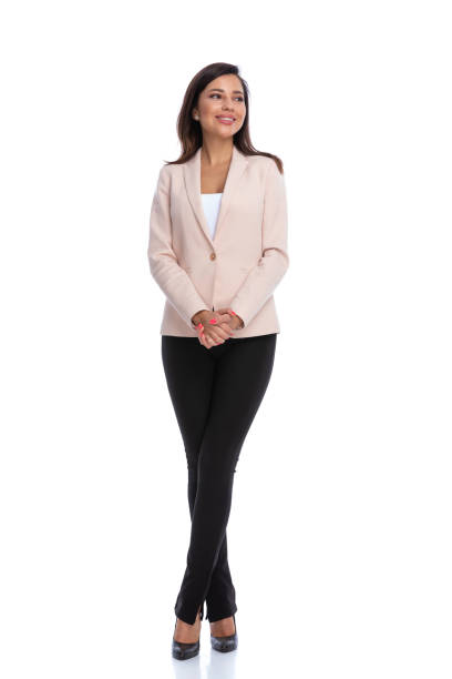 istock Happy businesswoman smiling while standing with legs crossed 1277303704