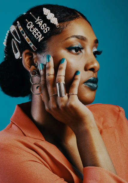 Studio shot of a beautiful young woman wearing hair clips against a blue background