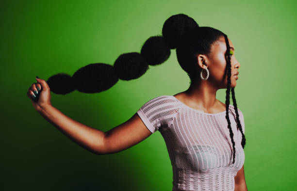 I have the confidence to rock any hairstyle I desire Shot of a young woman posing against a green background with a trendy hairstyle black woman hair extensions stock pictures, royalty-free photos & images