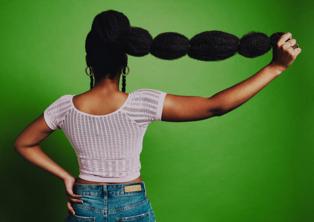 The longer the hair, the bigger the dreams Shot of a young woman posing against a green background with a trendy hairstyle black woman hair extensions stock pictures, royalty-free photos & images