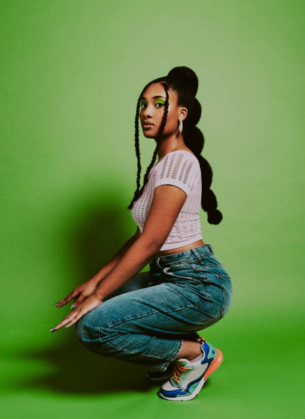 Your style is what sets you apart Shot of a young woman posing against a green background with a trendy hairstyle black woman hair extensions stock pictures, royalty-free photos & images