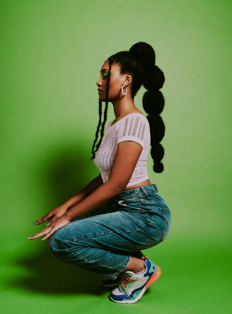 If it's trending, I'm on it Shot of a young woman posing against a green background with a trendy hairstyle black woman hair extensions stock pictures, royalty-free photos & images