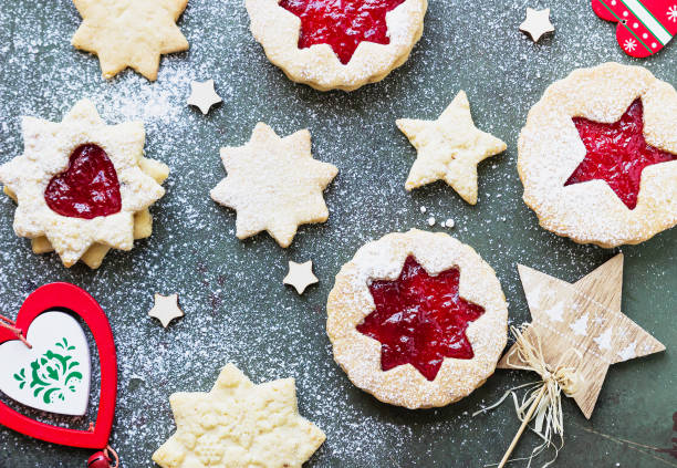 istock Traditional Linzer Christmas cookies with raspberry jam on green stone background. Top view. Flat lay. Festive decoration. 1277311428