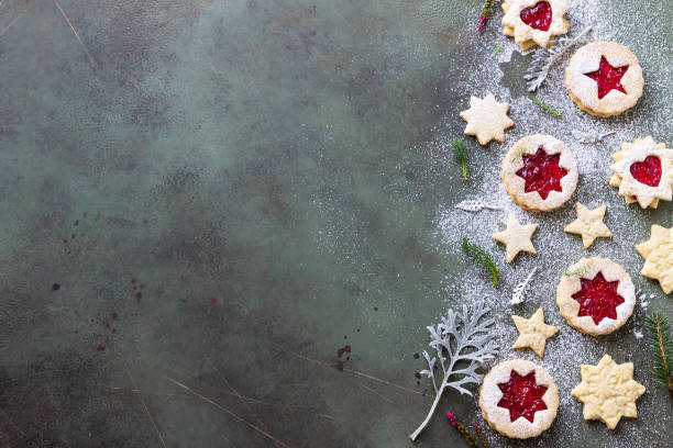 istock Traditional Linzer Christmas cookies with raspberry jam on green stone background. Top view. Flat lay. Festive decoration. Copy space. 1277311465