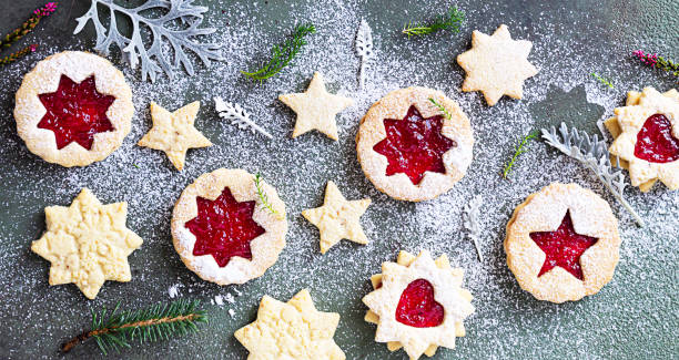 istock Traditional Linzer Christmas cookies with raspberry jam on green stone background. Top view. Flat lay. Festive decoration. 1277311493