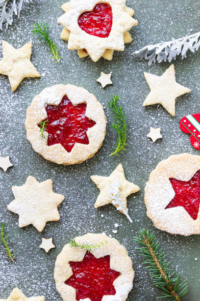 istock Traditional Linzer Christmas cookies with raspberry jam on green stone background. Top view. Flat lay. Festive decoration. 1277312934