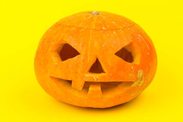 istock Halloween pumpkin head jack lantern on yellow background 1277316610