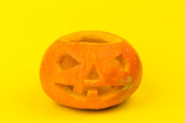 istock Halloween pumpkin head jack lantern on yellow background 1277316703