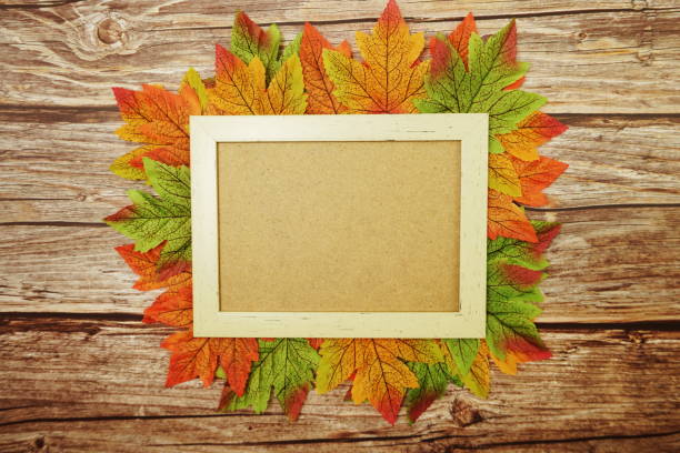 istock Maple leaves with space copy on wooden background 1277317435