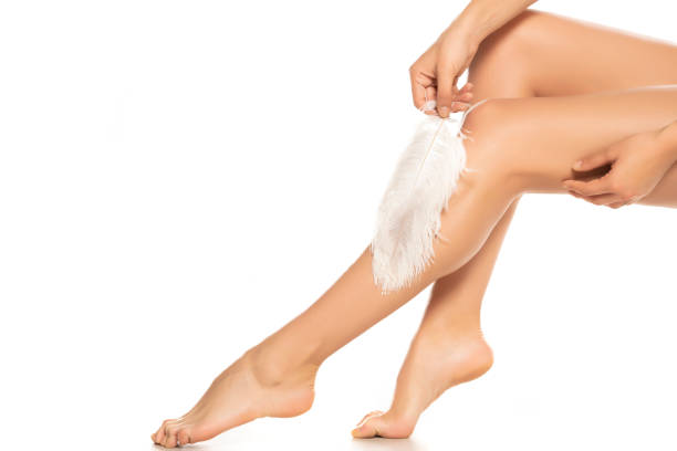 istock Woman touches her legs with white feather 1277317711