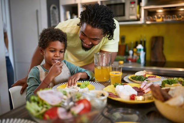 istock Afro-American male child eating in kitchen 1277318678