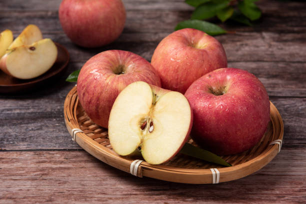 istock Ripe red apples  with clipping path on wooden table 1277323084