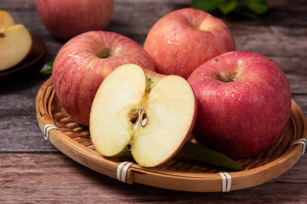 istock Ripe red apples  with clipping path on wooden table 1277323601