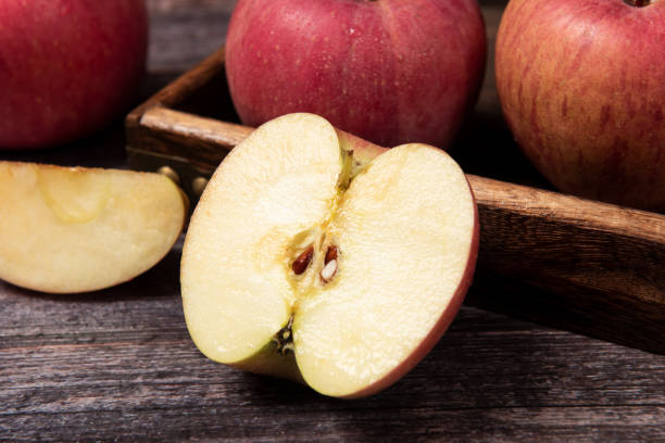 istock Ripe red apples  with clipping path on wooden table 1277324087