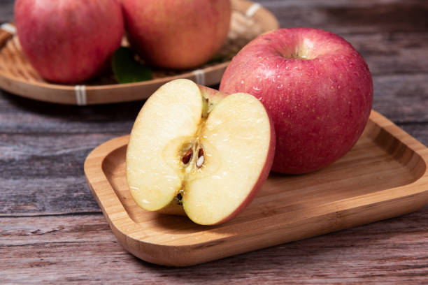 istock Ripe red apples  with clipping path on wooden table 1277325189