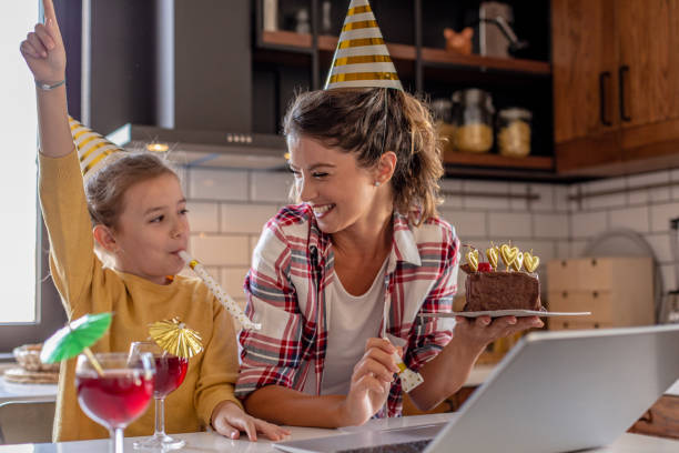 istock Mother and daughter having online celebration at home 1277325266