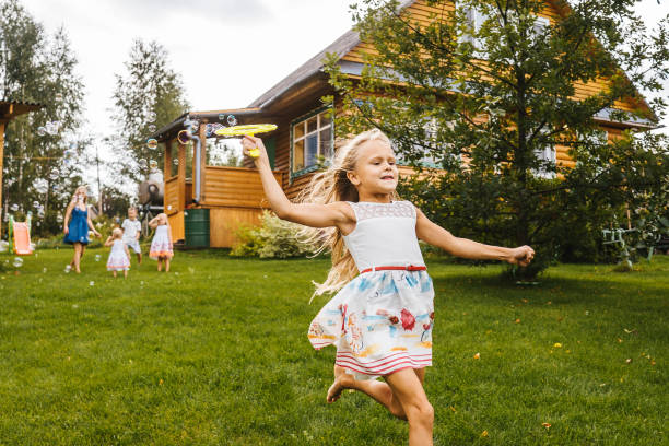 istock Little girl run with blowing soap bubbles 1277325279