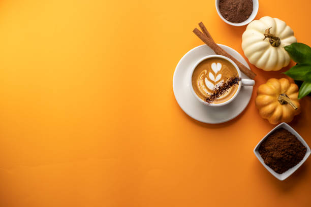 pumpkin spice latte on a orange background - latté pumpkin spice coffee imagens e fotografias de stock