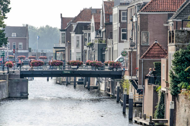 Gorinchem, the Netherlands, September 23, 2020: view along Linge river running downtown with bridges crossing and adjacent historical houses