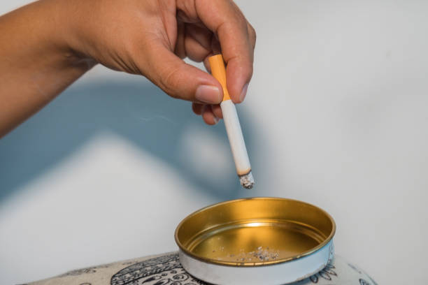 istock Woman smoking cigarette and using an ashtray 1277331426